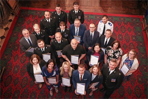 Image of the 22 recipients with their comendations at the Exceptional Contribution to Policing in Devon Awards