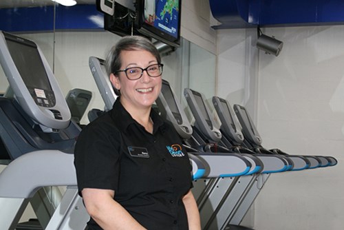 Image of Kerry in front of the treadmills at Culm Valley Sports Centre